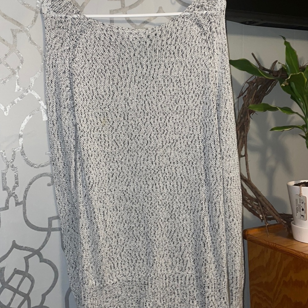 Super cute sweater , holes down the back size medium but could fit a large